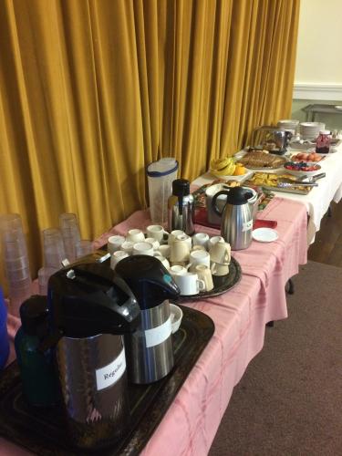 a continental breakfast spread featuring fruit, coffee, and pastries